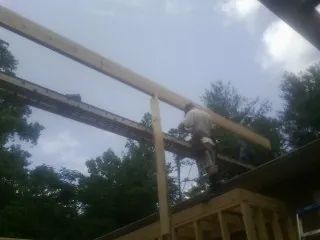 Carpenter setting a ridge beam over a new addition frame — Ice Dam Removal by Roofing Brothers in Moyie Springs