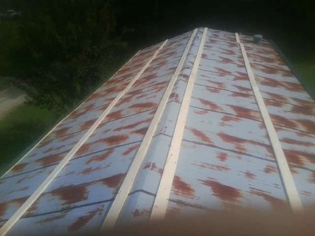Rusted metal roof panels with new wood purlins before replacement — Storm Damage Roof Repair in Moyie Springs by Roofing Brothers